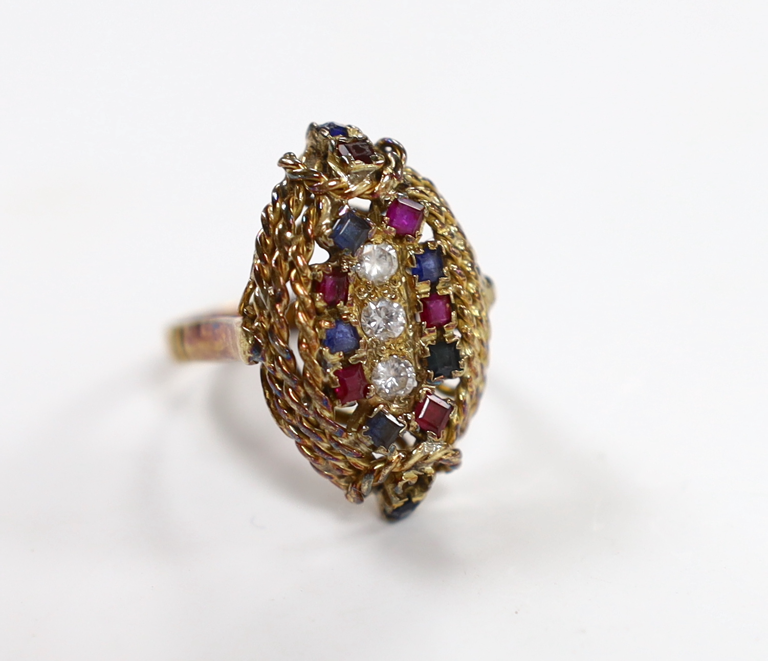 A 750 yellow metal, ruby, sapphire and diamond cluster set oval dress ring, size P, gross weight 9.3 grams.